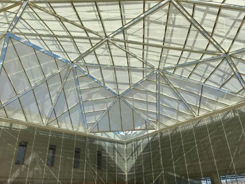Image inside the atrium looking up at the glass dome
